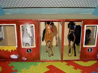 play horses inside painted barn