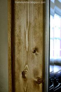 wood frame with metallic detail on mirror