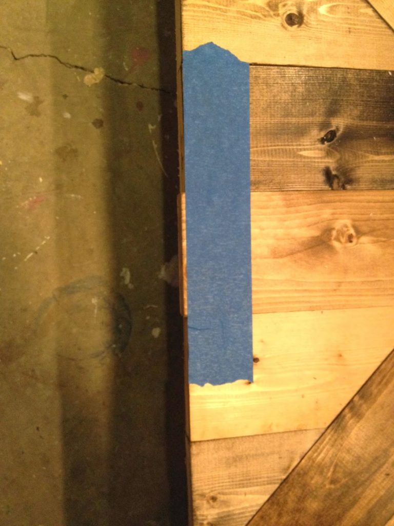 tape on edge of wood to protect finish when trimming excess