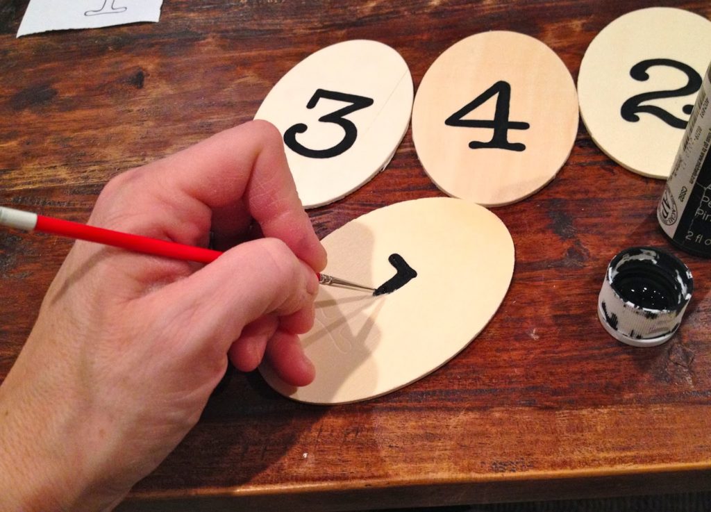 handpainting numbers onto wood tags