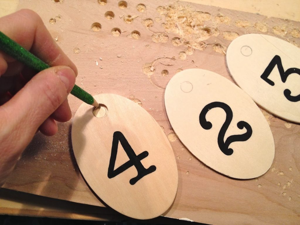 marking wood tags for hole to drill at top