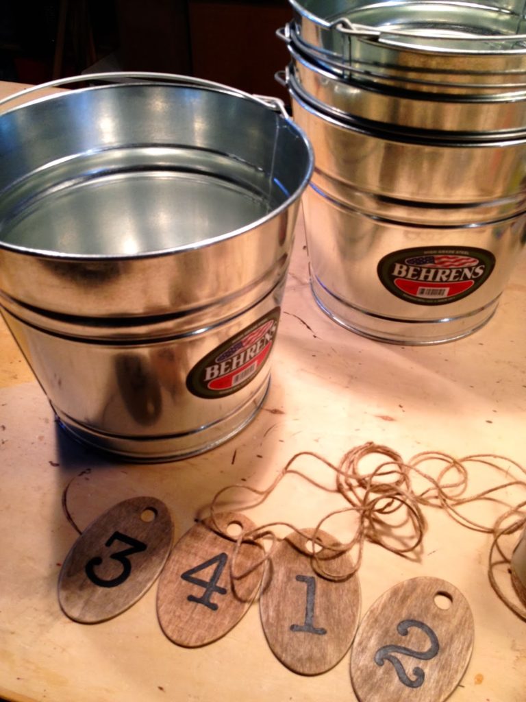 attaching wood tags to buckets with string