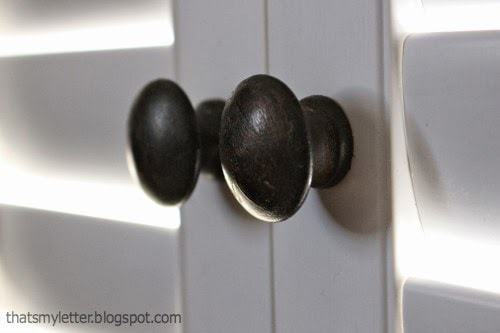wood knobs on white shutters
