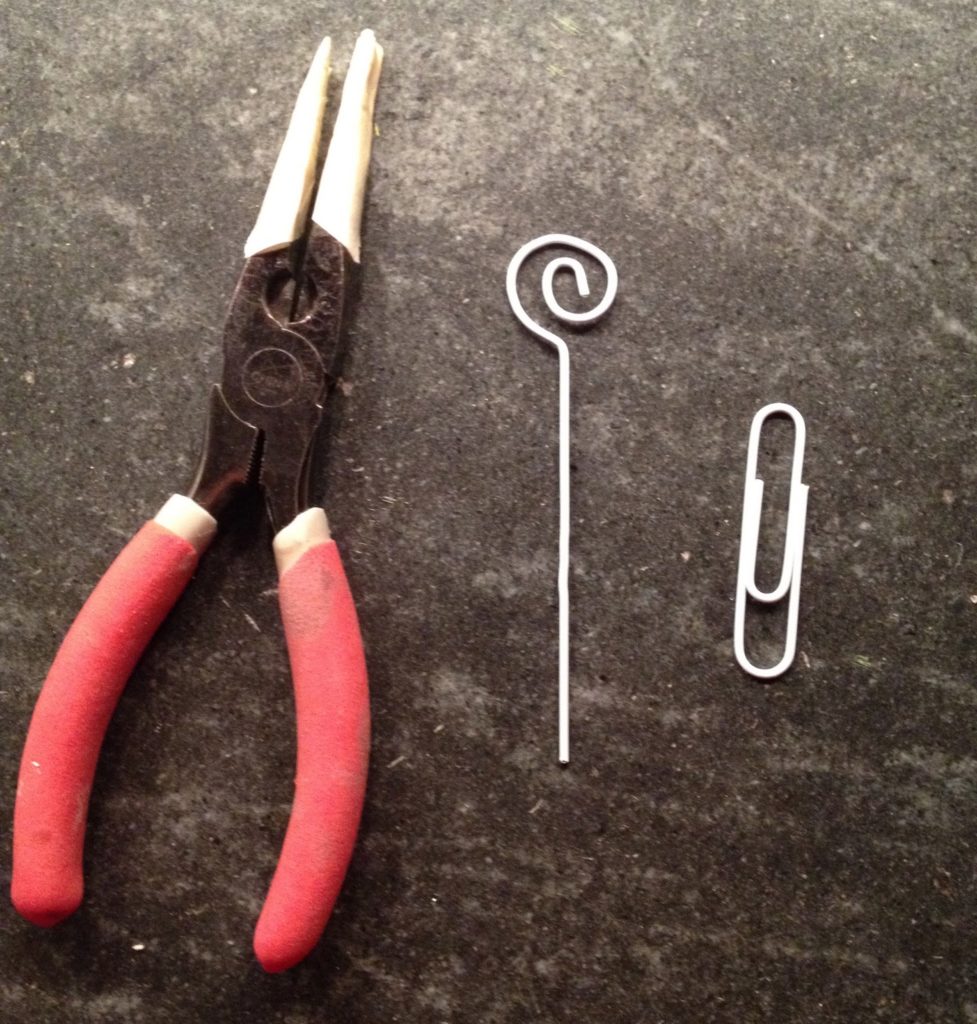 bending paper clip into holder