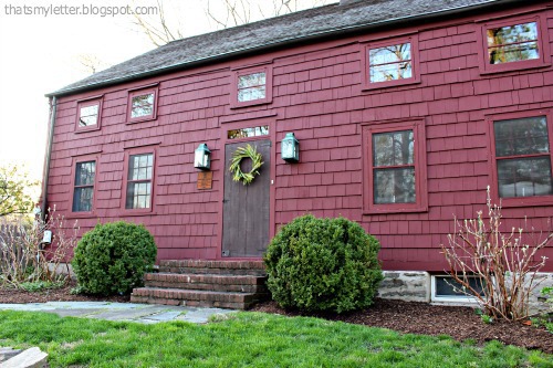 primitive red farmhouse with wreath