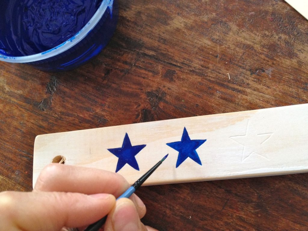 handpainting stars onto wood