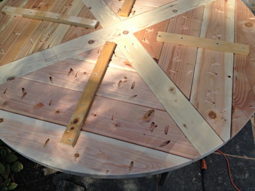planked circular dining table underside view