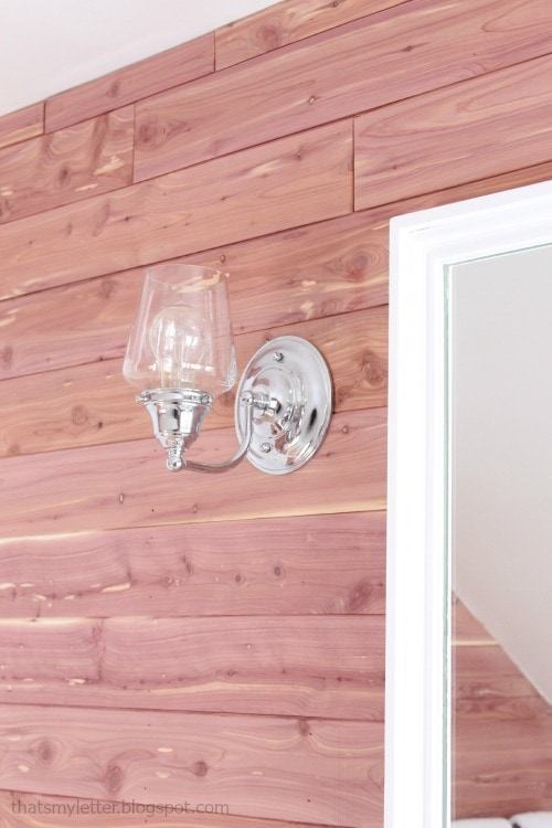diy bathroom makeover clear glass sconces cedar planked walls