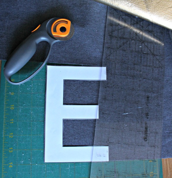 cutting out letters from gold fabric