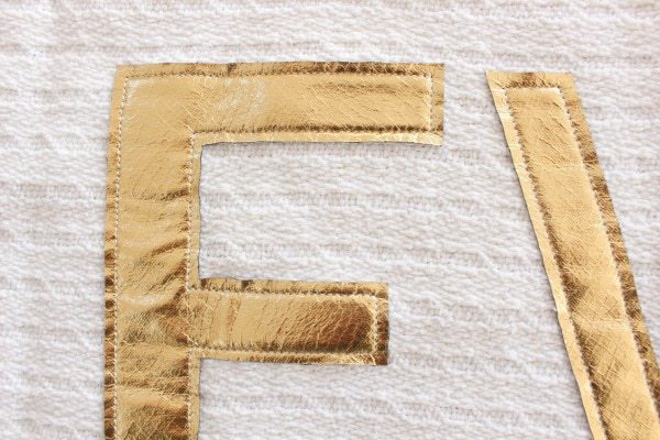 top stitch gold letters in position