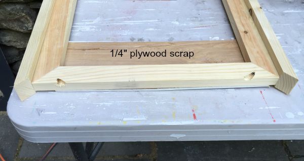 1/4" scrap plywood spacer under frame front