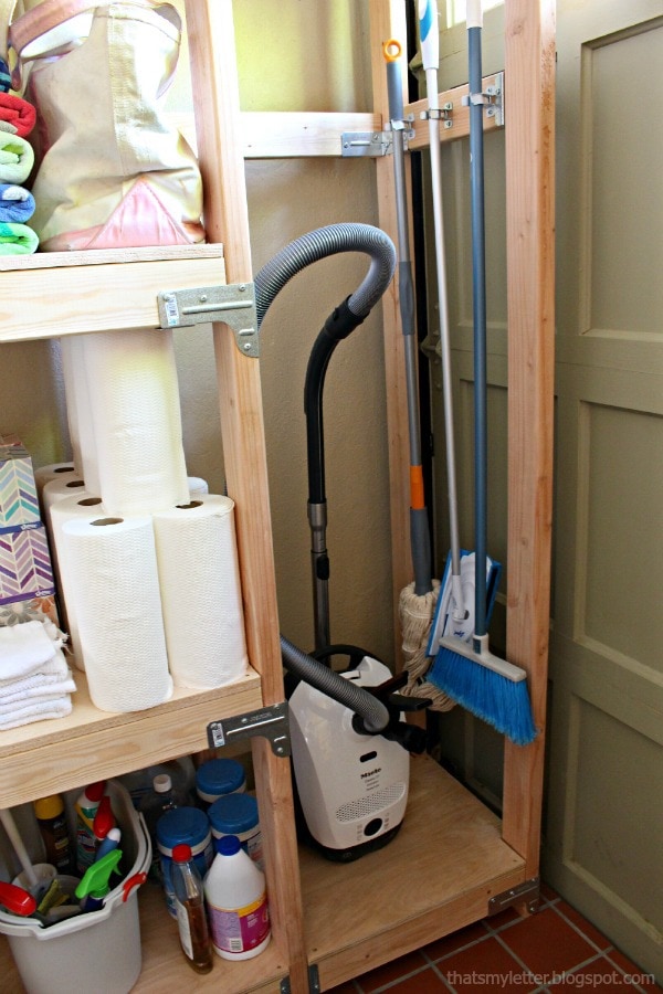vacuum and broom storage