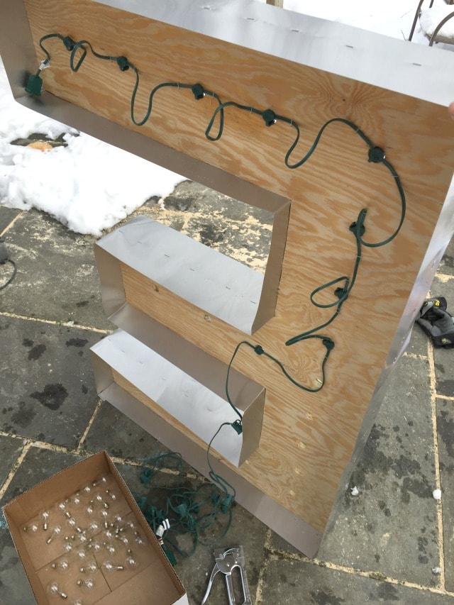 installing outdoor string lights to marquee letters