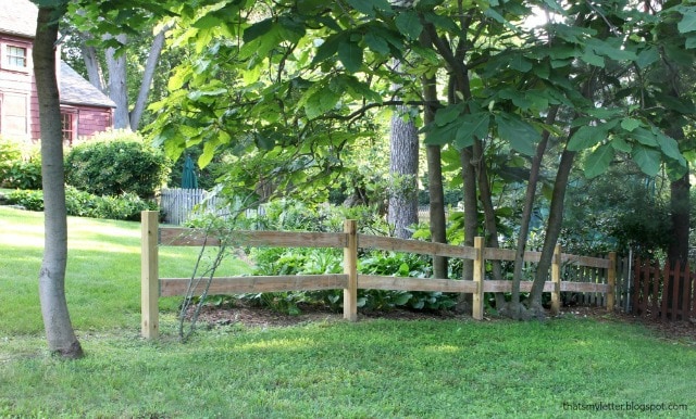 split rail fence in corner of yard