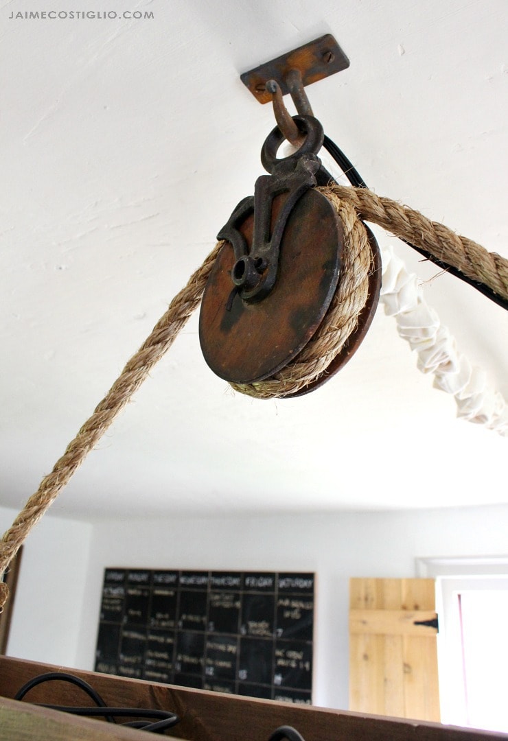 antique farming pulley for hanging light fixture