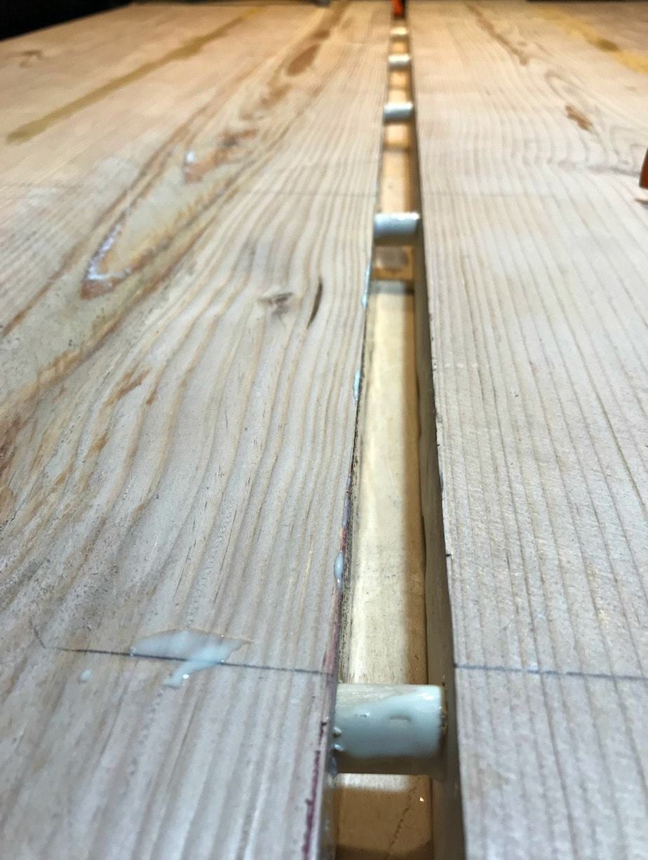 farmhouse table hammering boards together